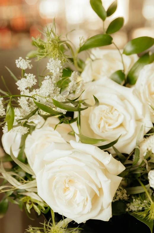 there is a bouquet of white roses on the table