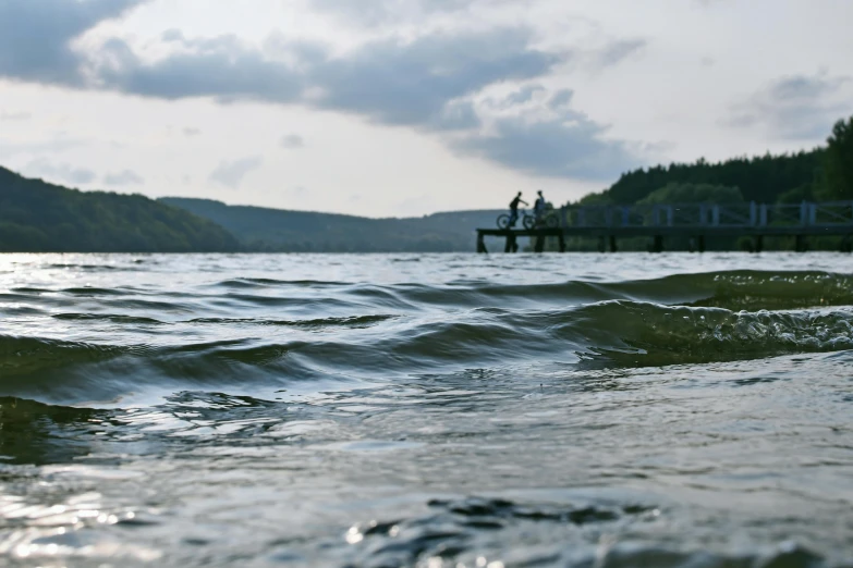 people walking on a pier over a body of water