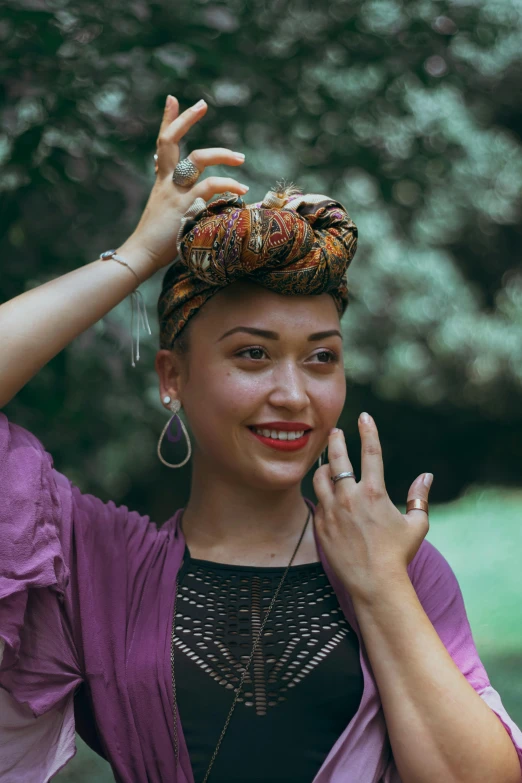 a woman wearing an ethnic head scarf in the park