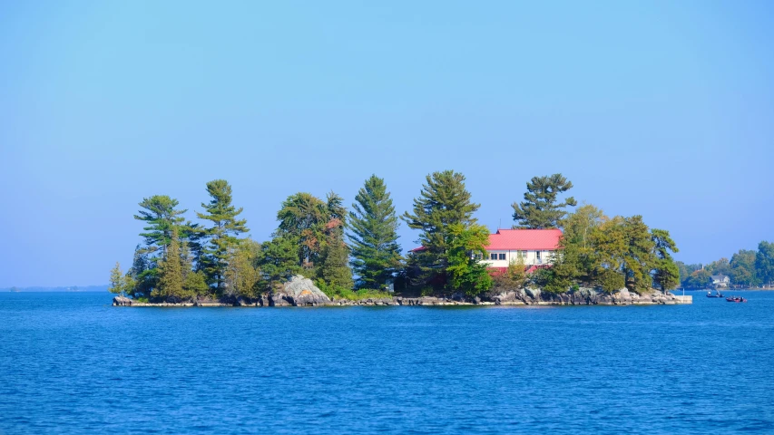 a house sitting on top of an island in the ocean