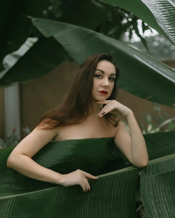 a woman in a green dress sitting on a green chair