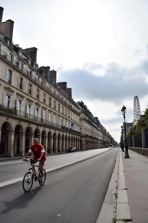 man riding a bike down a city street