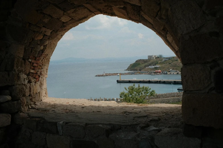 a view of the ocean out an old window