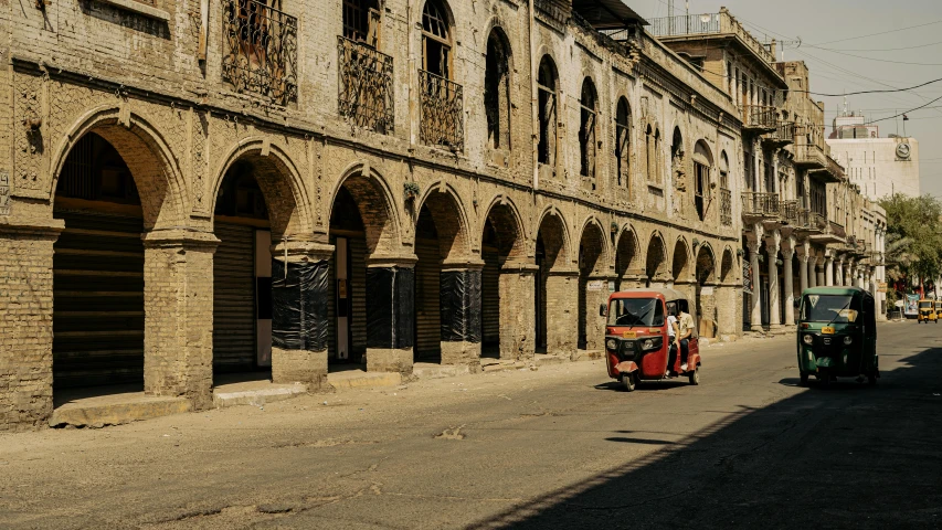 an old truck is next to the curb