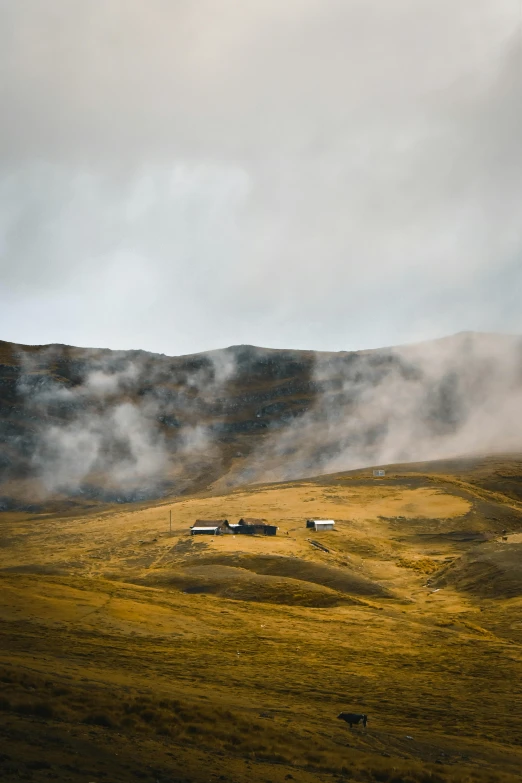 fog on the mountain beside a grassy hill