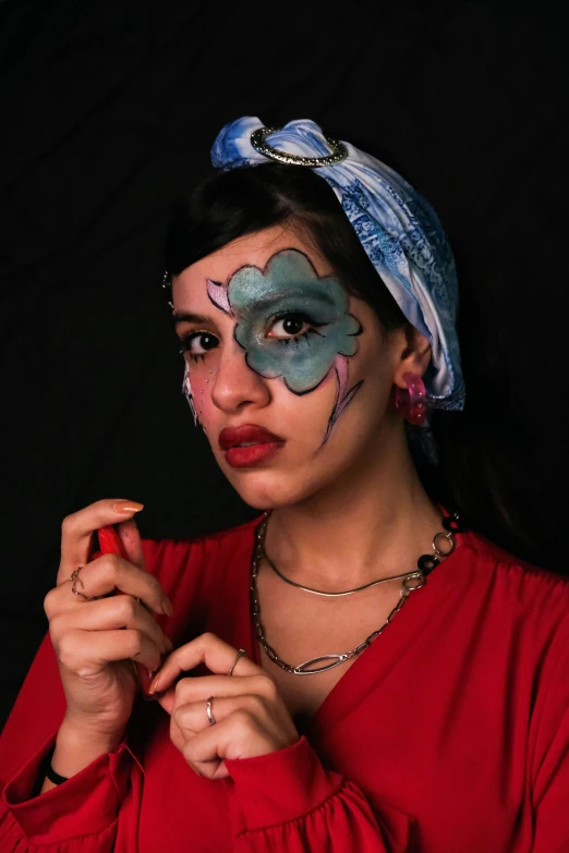 a woman with face paint in a red shirt