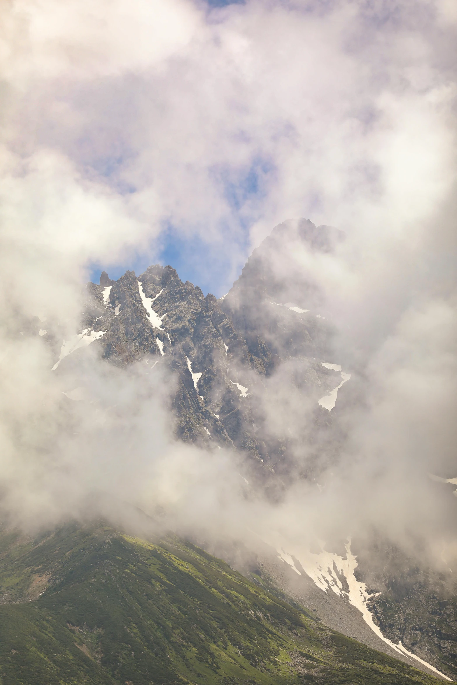 a snow capped mountain with low cloud cover