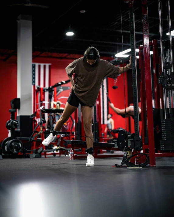 a person is exercising on the pull ups machine