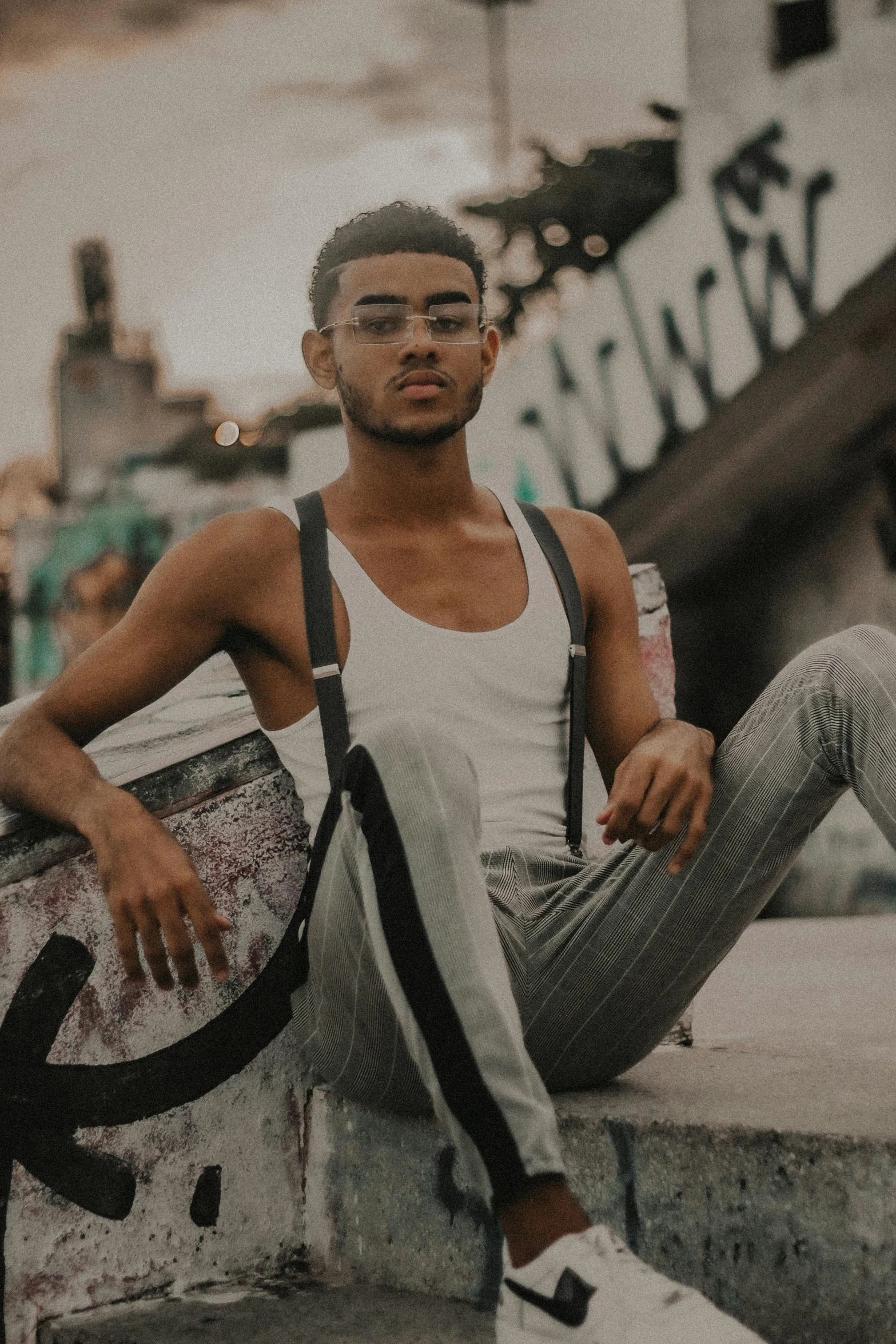 a man sits on top of a luggage bag