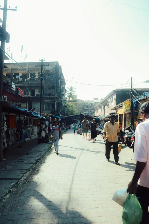 a narrow cobblestone street lined with shops