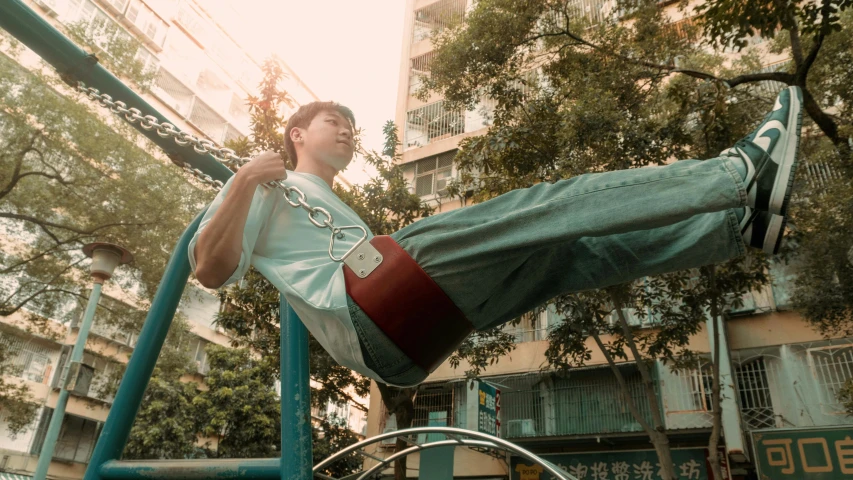 the boy is riding on a slide in the park