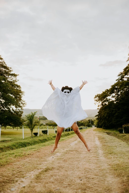 woman wearing a dress while dancing on the road