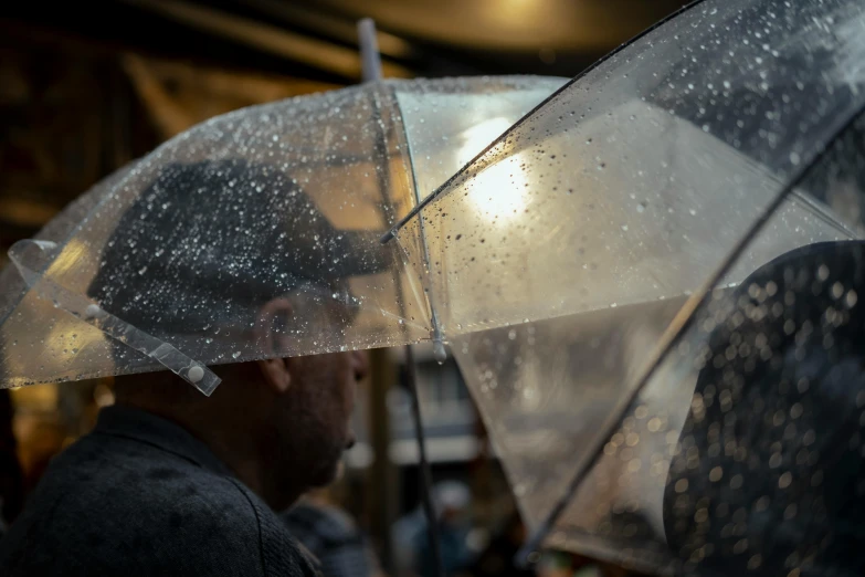 a man with an umbrella with white flecks