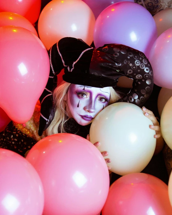 a woman in costume hiding in balloons