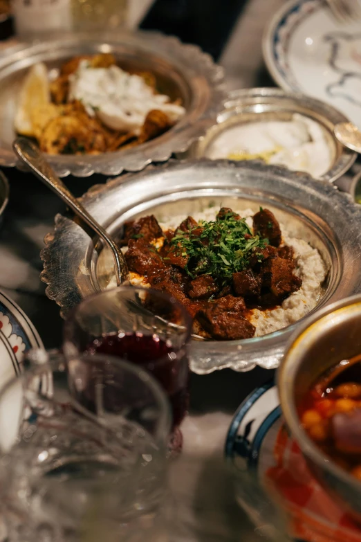 a silver bowl filled with food on top of a counter