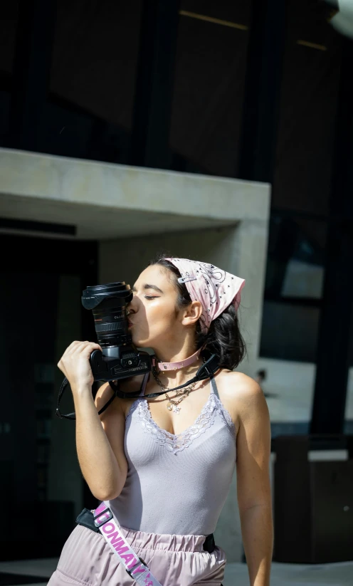 woman with camera up to her mouth outside