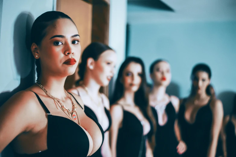 women lined up in swimsuits standing next to each other