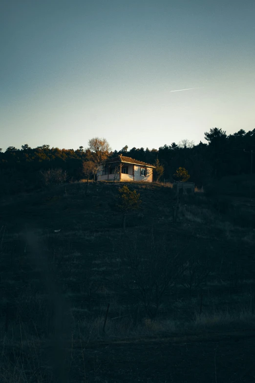 a house is sitting on top of a hill