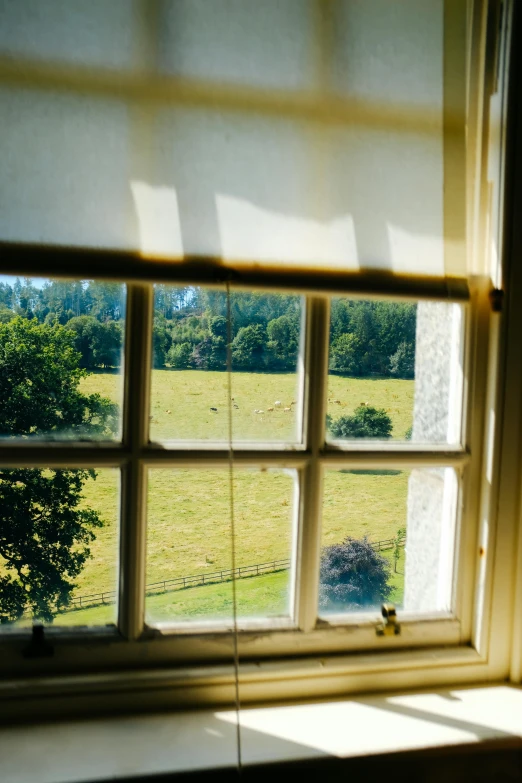 a view out of a window looking at a field