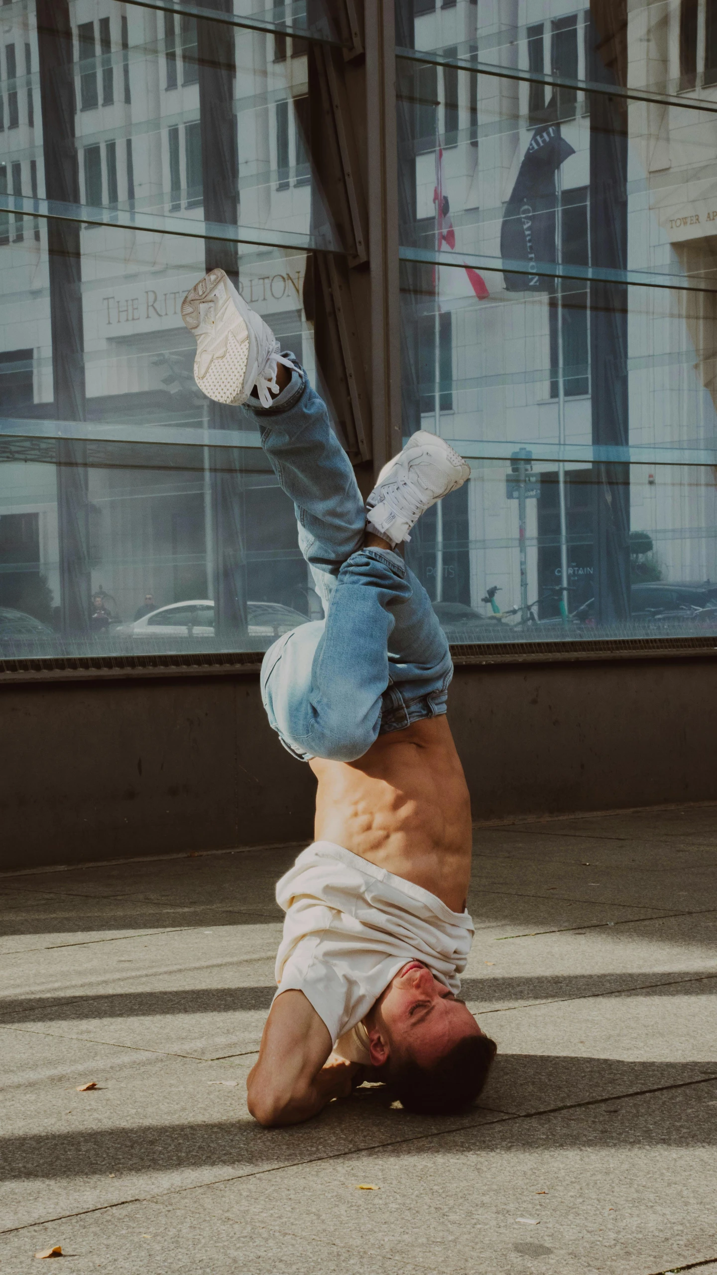 the young man is upside down outside