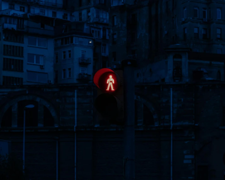 a traffic light with an illuminated pedestrian symbol on it