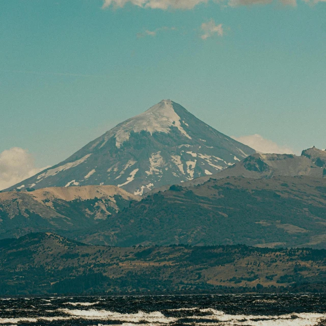 an airplane flying above a snow capped mountain