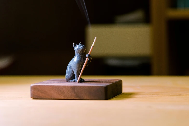 a wooden stand with a smoke cat next to it