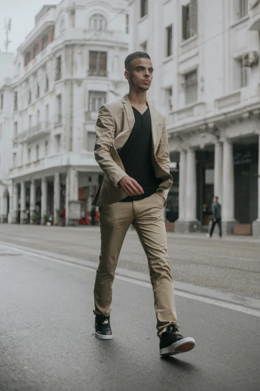 a man wearing brown slacks is on a skateboard