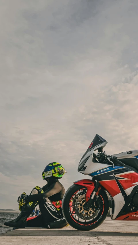 two motorcyclists are parked on the beach together