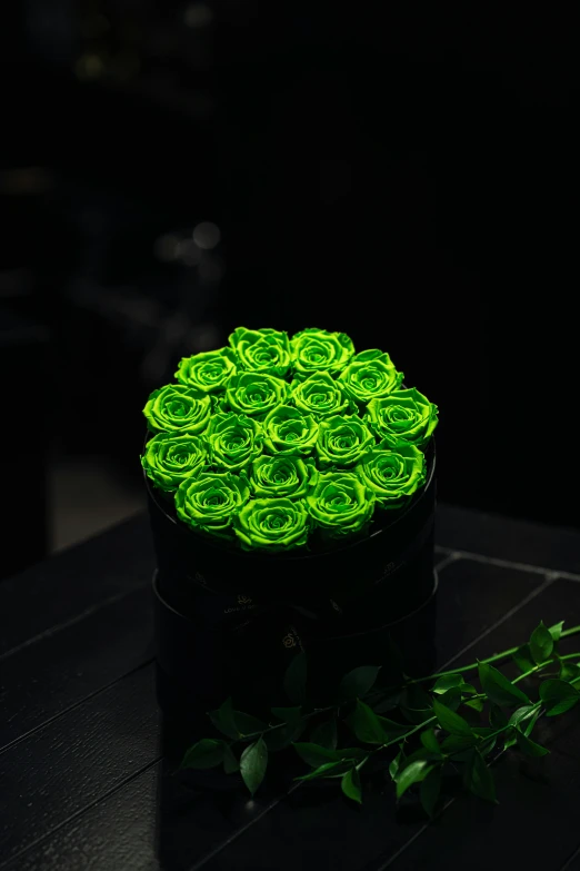 a green flower glowing in the dark with a small green stem