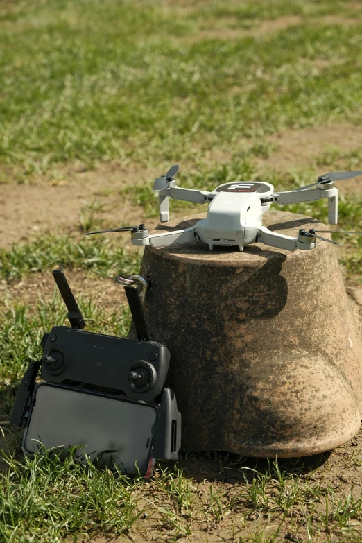 a bag laying in the grass next to a remote