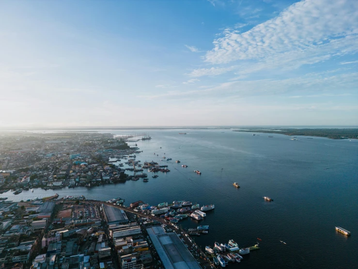 an aerial view of the ocean with boats on it