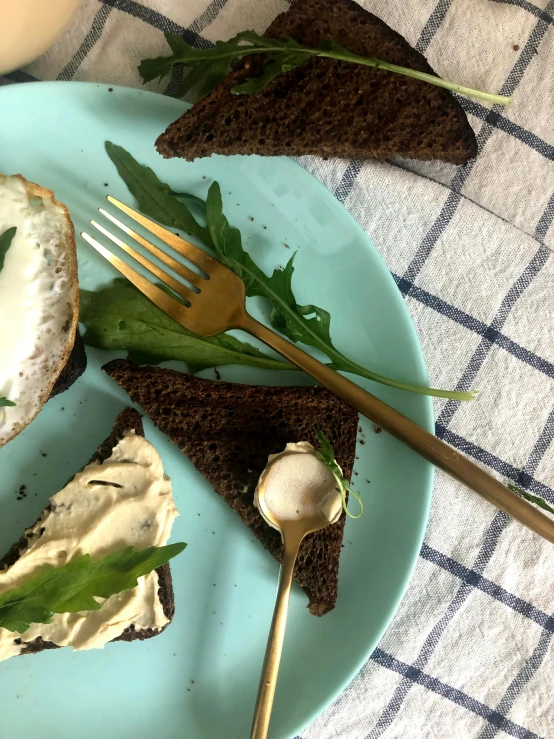 two pieces of bread are on a plate with two forks