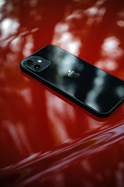 the back end of a red car with the iphone on it