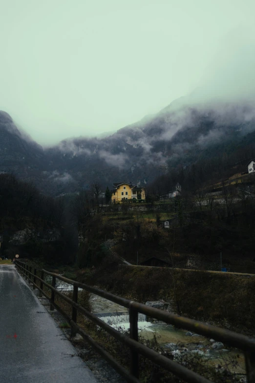 a road near the mountains with fog