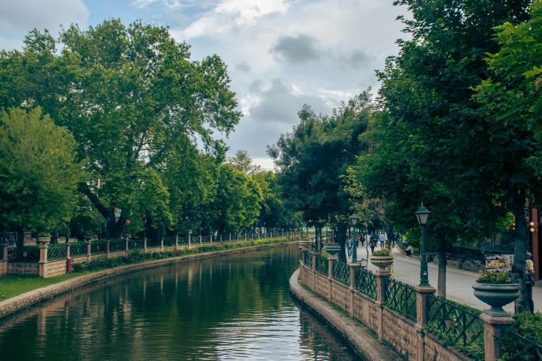 a person walking down a street by the water