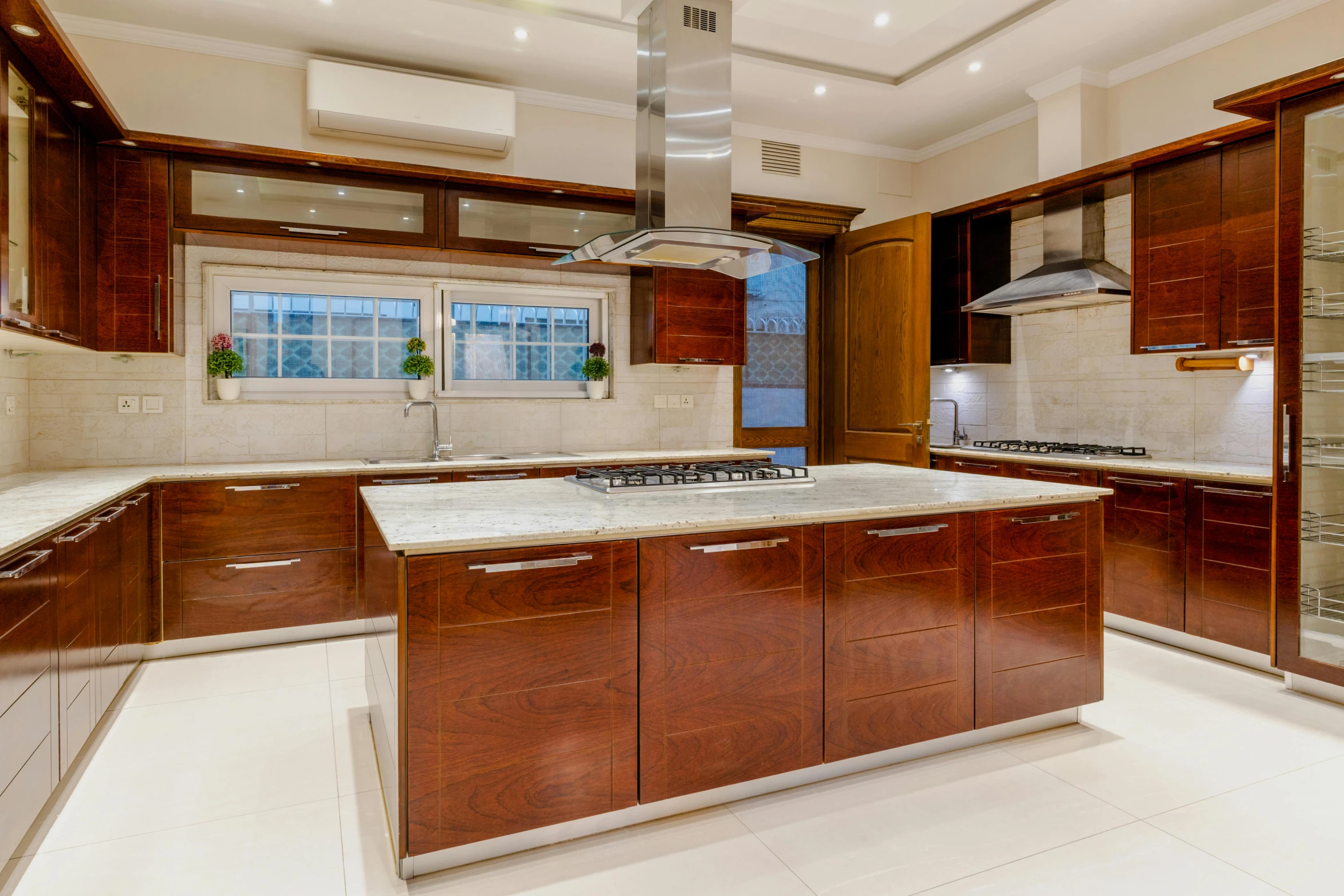 this kitchen has marble counter tops and wooden cabinets