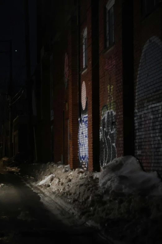 the street in front of some buildings with graffiti on it