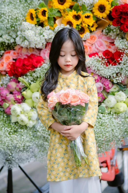 little girl in front of a huge bouquet of flowers