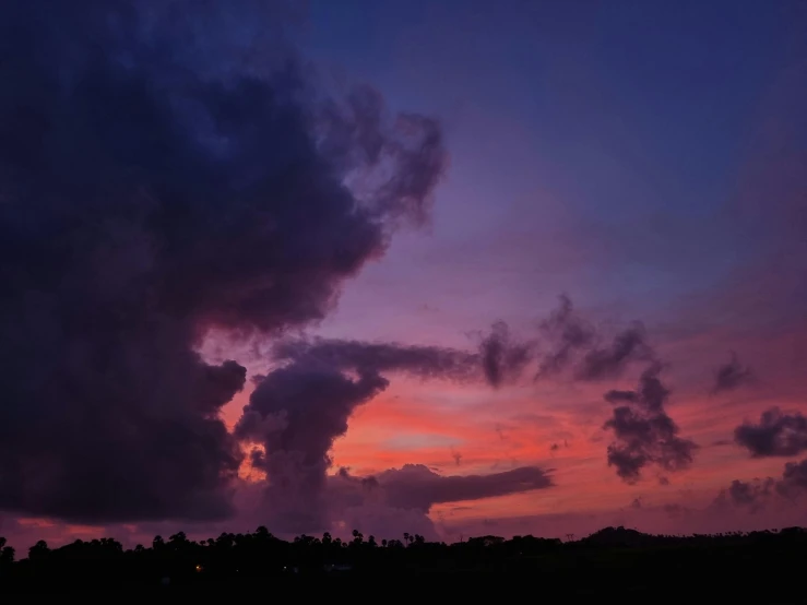 colorful clouds over an empty field at dusk