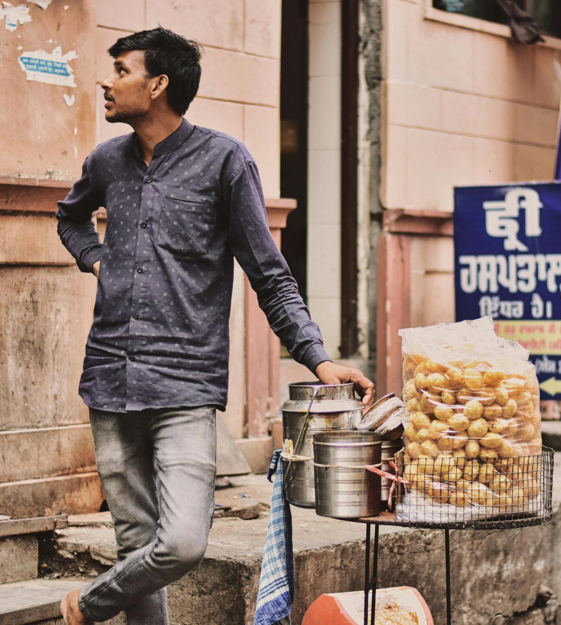 a man that is walking past a basket of food