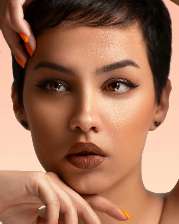 woman with short dark hair and orange nail polish