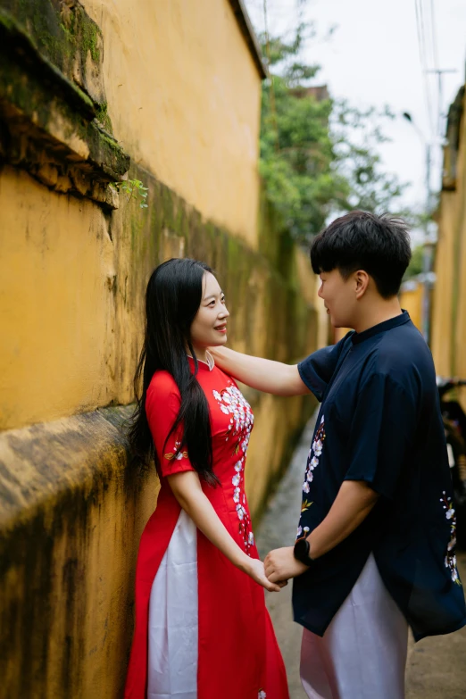 the young man is touching the girl's hand while she smiles