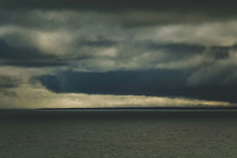 some very pretty clouds with a body of water in the background