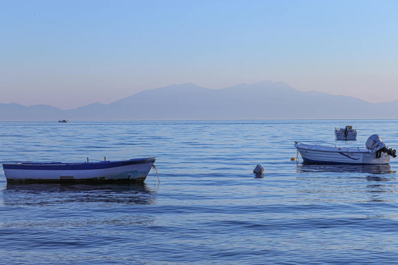 two boats that are floating in the water