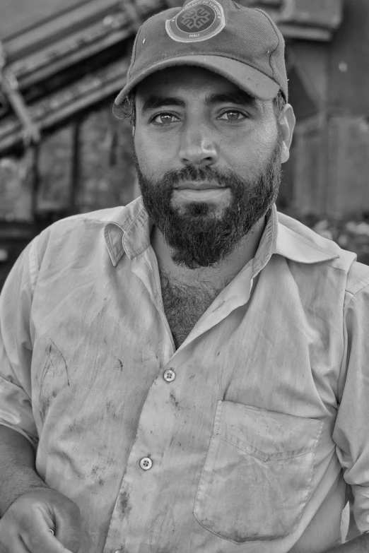 black and white portrait of man with beard wearing a baseball cap