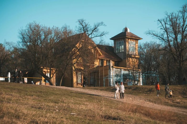 a group of people that are standing outside a house