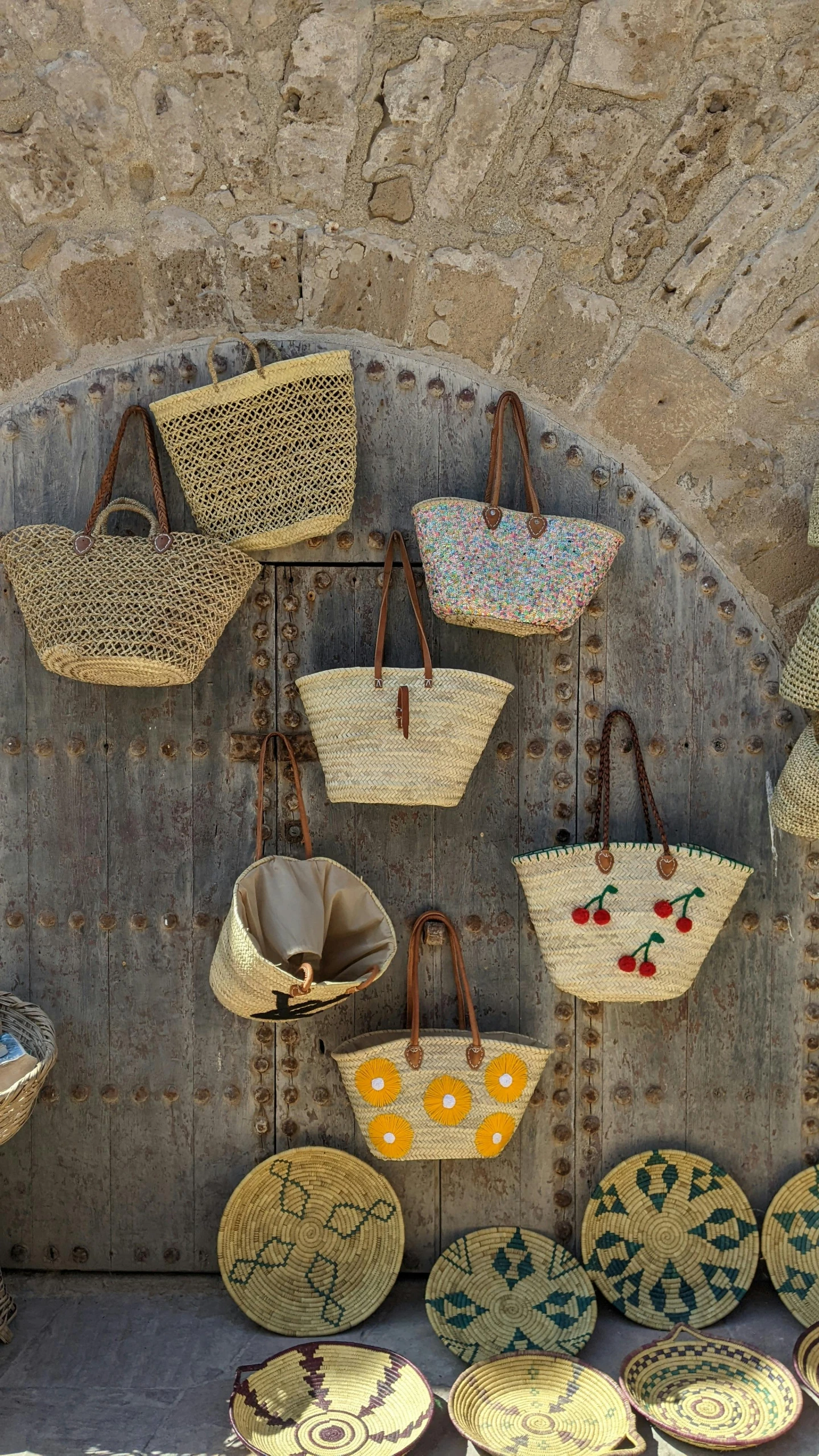 different woven baskets hang on the wall