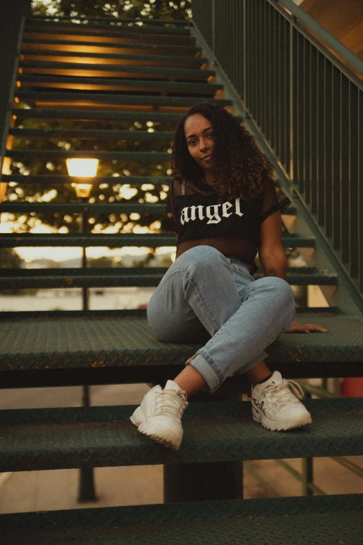 a woman sitting on steps with her feet up and smiling