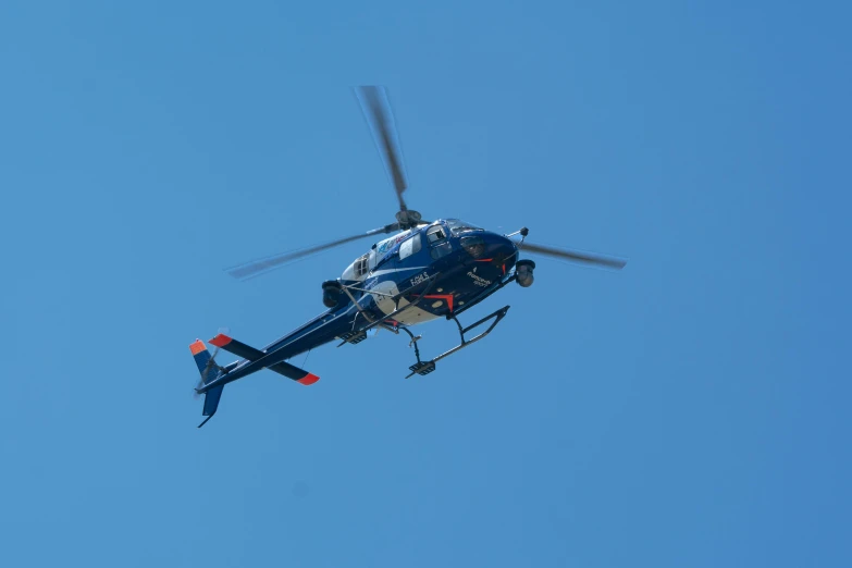 a helicopter flying through the air with propellers on